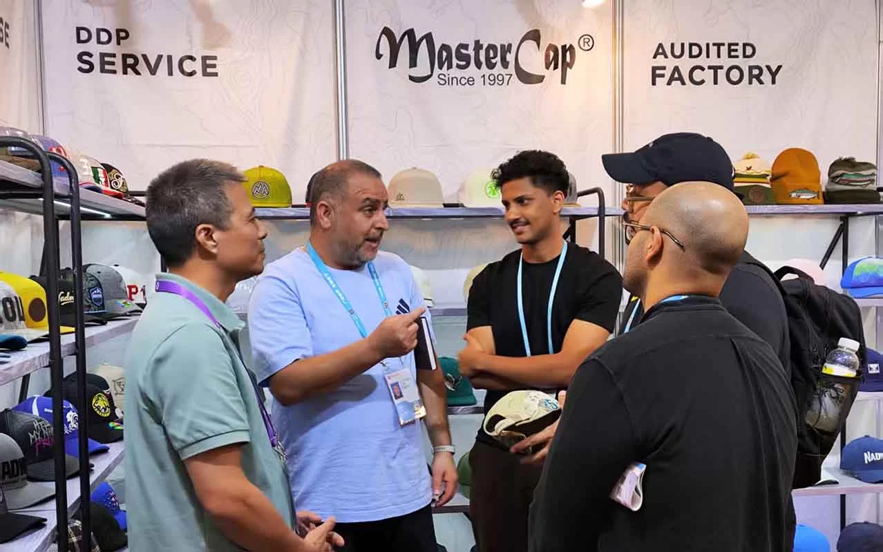 Buyers selecting cap styles from MasterCap's new collection displays at Canton Fair
