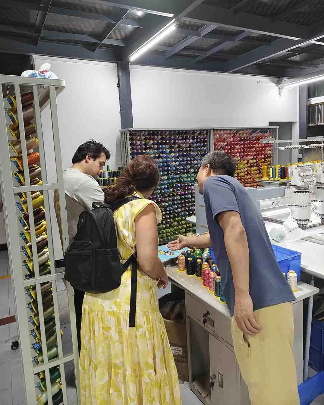 MasterCap team showing the extensive thread color matching room to clients